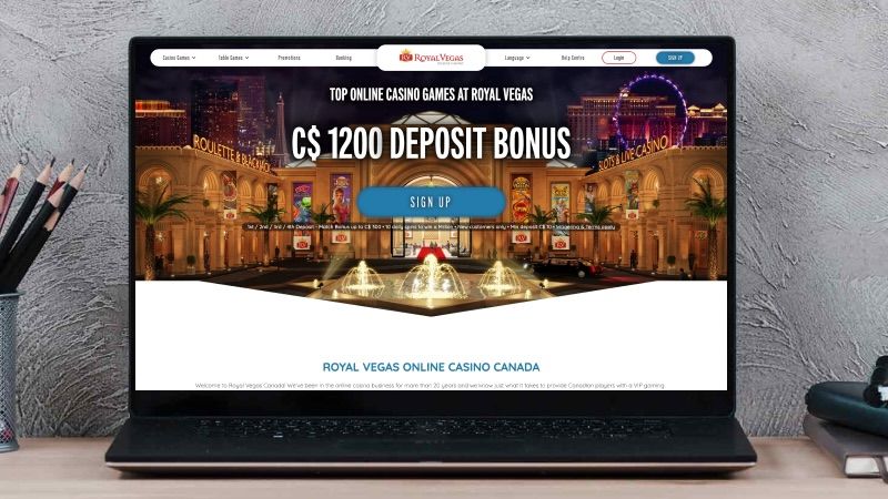a laptop mockup with the royal vegas casino main page in it