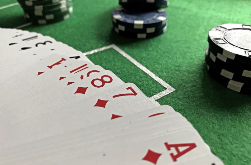 cards on the poker table with chips