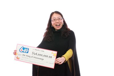 Woman hold check for 64 millions dollars.